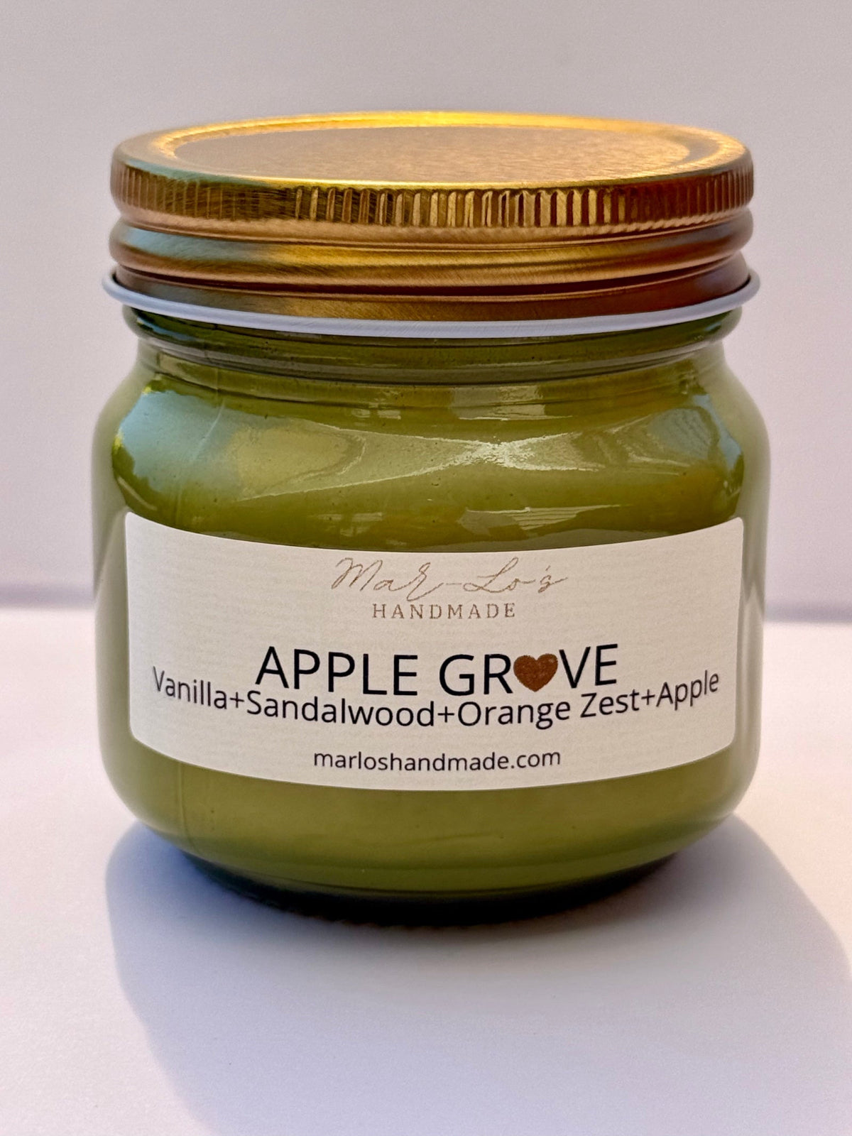 Apple Grove Candle in a green 7 oz Mason Jar with a gold lid and wooden wick