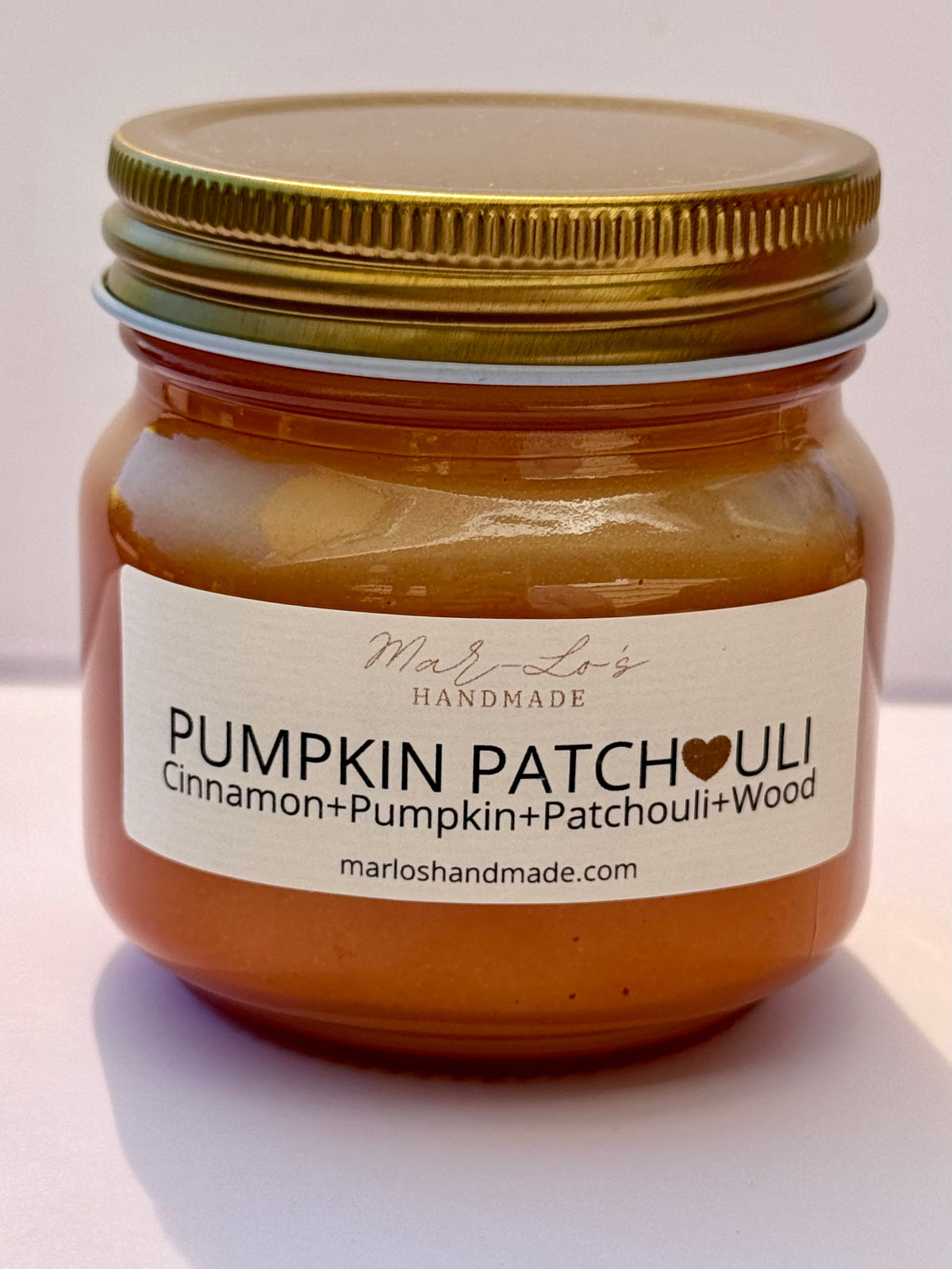 pumpkin patchouli mason jar candle with a gold lid and crackling wooden wick
